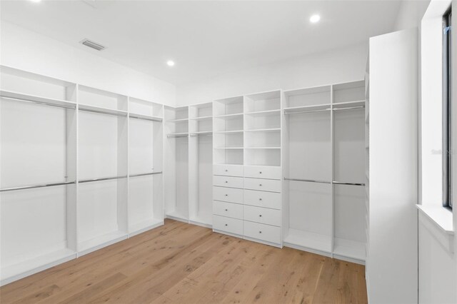 spacious closet featuring light hardwood / wood-style floors