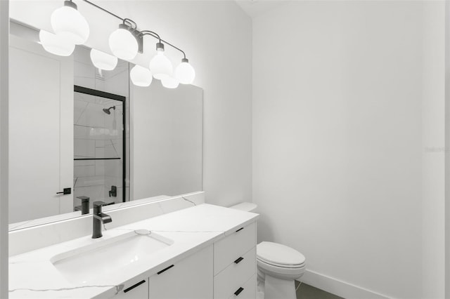 bathroom with vanity, toilet, and a shower with shower door