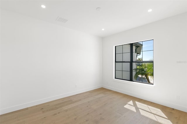 unfurnished room with light wood-type flooring