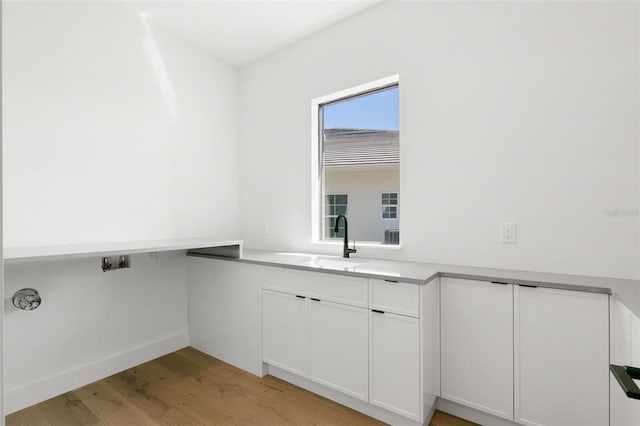 1810 4th St E, Palmetto, FL 34221 - laundry room featuring a sink and light wood-style flooring