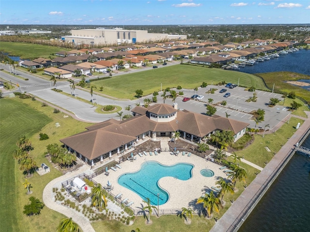 1810 4th St E, Palmetto, FL 34221 - aerial view of property and surrounding area featuring a large body of water, a pool area, and nearby suburban area