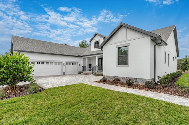 view of front of home with a front yard and a garage