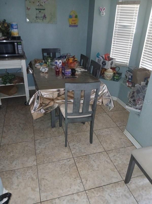 dining room with tile patterned flooring