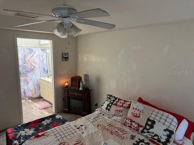 bedroom with ceiling fan and ensuite bath