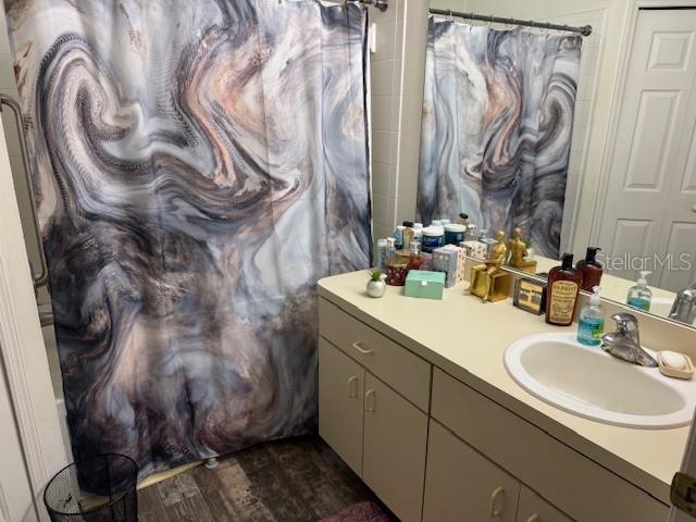 bathroom with hardwood / wood-style floors and vanity