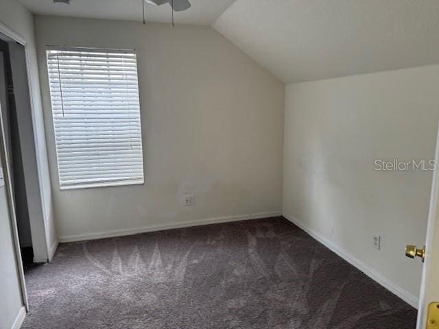 bonus room featuring lofted ceiling, ceiling fan, and dark carpet