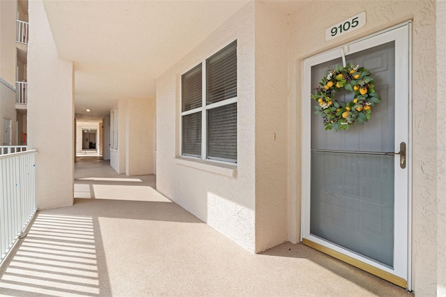 6450 Shoreline Dr Unit 9105, Saint Petersburg, FL 33708 - doorway to property with stucco siding and a balcony