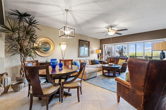 dining room featuring ceiling fan, a textured ceiling, and light tile patterned floors