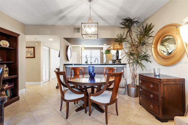 6450 Shoreline Dr Unit 9105, Saint Petersburg, FL 33708 - dining space with light tile patterned floors, visible vents, a textured ceiling, and a notable chandelier