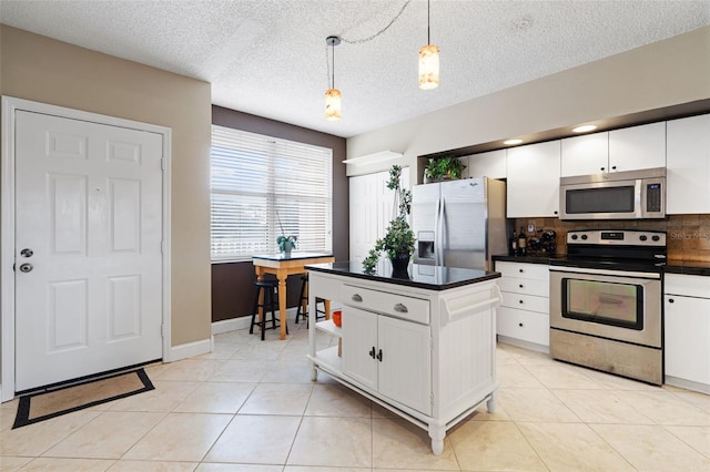 6450 Shoreline Dr Unit 9105, Saint Petersburg, FL 33708 - kitchen with pendant lighting, appliances with stainless steel finishes, white cabinets, and dark countertops