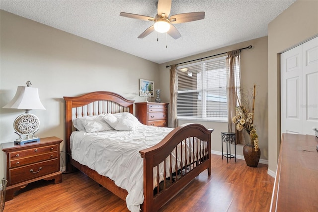 6450 Shoreline Dr Unit 9105, Saint Petersburg, FL 33708 - bedroom with baseboards, a textured ceiling, ceiling fan, and wood finished floors