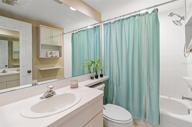 full bathroom with vanity, shower / tub combo, and toilet