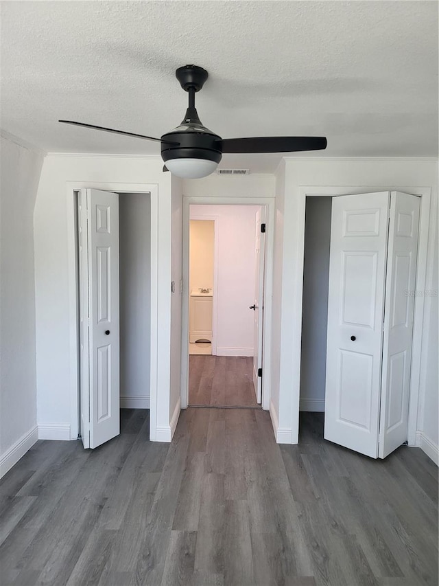 unfurnished bedroom with ceiling fan, hardwood / wood-style floors, and a textured ceiling