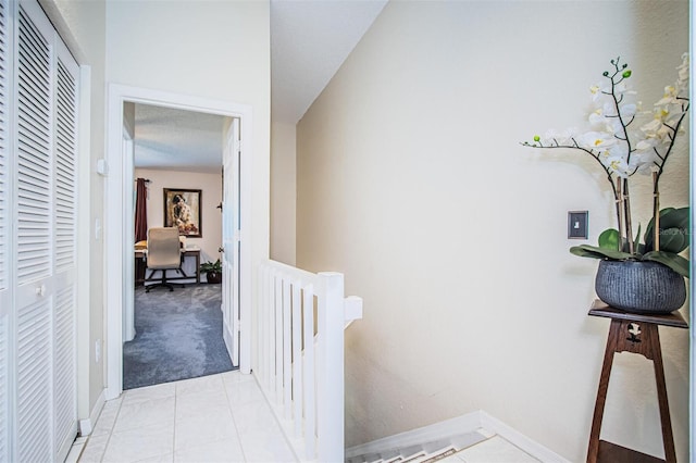 hallway with light colored carpet