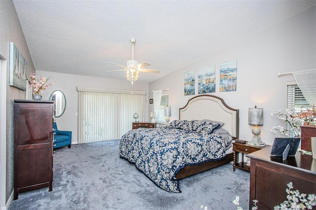 bedroom with carpet floors, a textured ceiling, vaulted ceiling, and ceiling fan