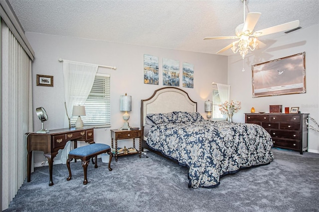 carpeted bedroom featuring a closet, ceiling fan, and a textured ceiling