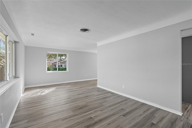 4300 16th Ave N, Saint Petersburg, FL 33713 - spare room featuring baseboards, visible vents, and wood finished floors