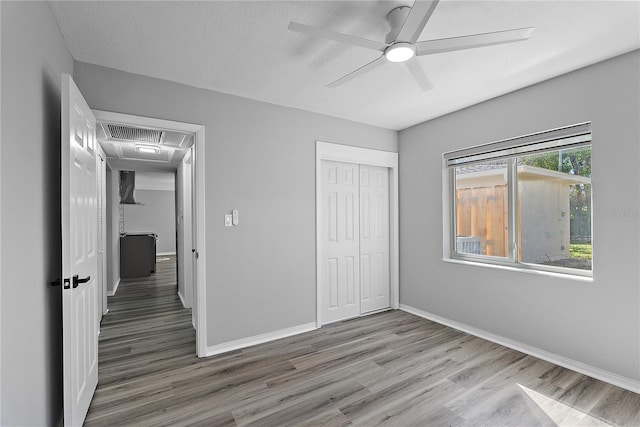 4300 16th Ave N, Saint Petersburg, FL 33713 - unfurnished bedroom with baseboards, a closet, ceiling fan, and wood finished floors