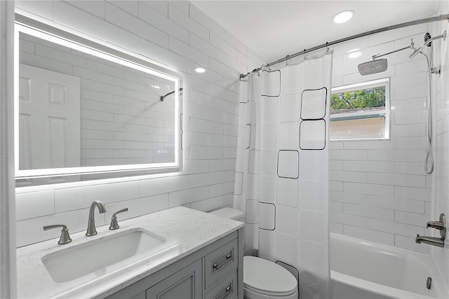 full bathroom featuring tasteful backsplash, toilet, shower / bath combo with shower curtain, tile walls, and vanity