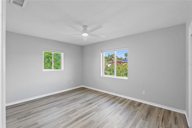 empty room featuring light wood-type flooring and ceiling fan