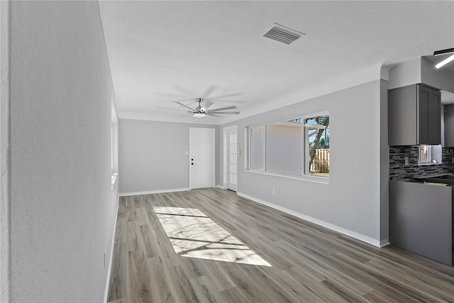 unfurnished living room featuring light hardwood / wood-style floors and ceiling fan