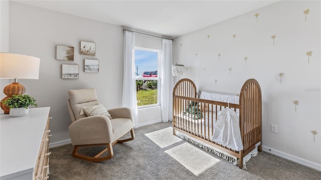 carpeted bedroom featuring a nursery area