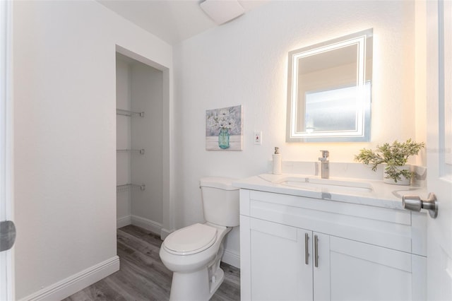 bathroom featuring vanity, toilet, and hardwood / wood-style flooring