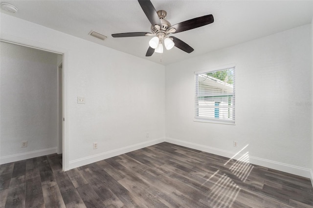 empty room featuring dark wood-type flooring and ceiling fan