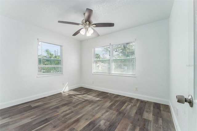 empty room with dark wood-type flooring, ceiling fan, a textured ceiling, and plenty of natural light