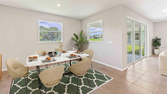 dining space featuring light tile patterned flooring