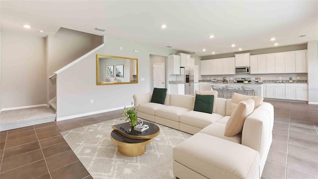 tiled living room featuring vaulted ceiling