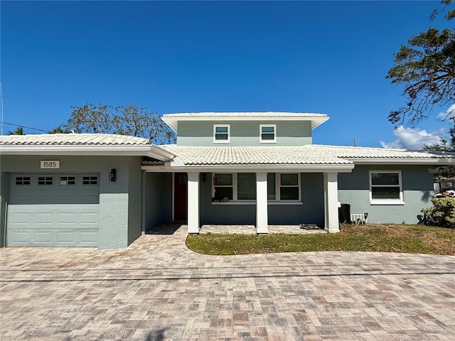 view of front of home featuring a garage and central AC unit