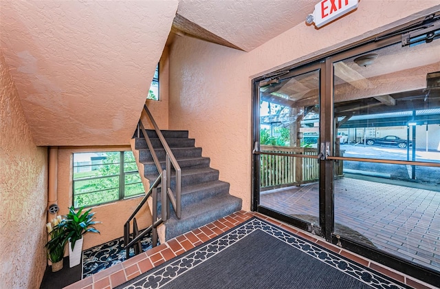 stairway with a textured ceiling