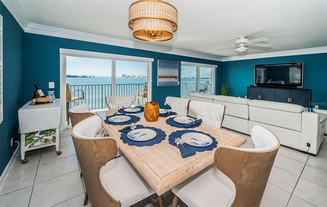 tiled dining room featuring ceiling fan and crown molding