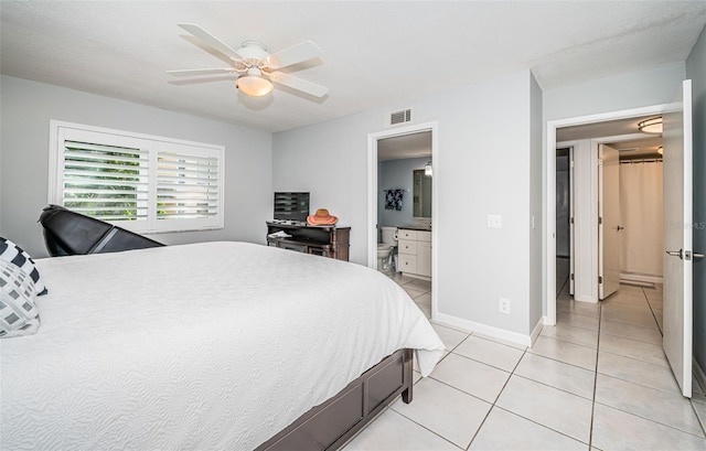 tiled bedroom with ensuite bath and ceiling fan