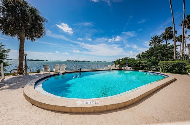 view of swimming pool with a water view