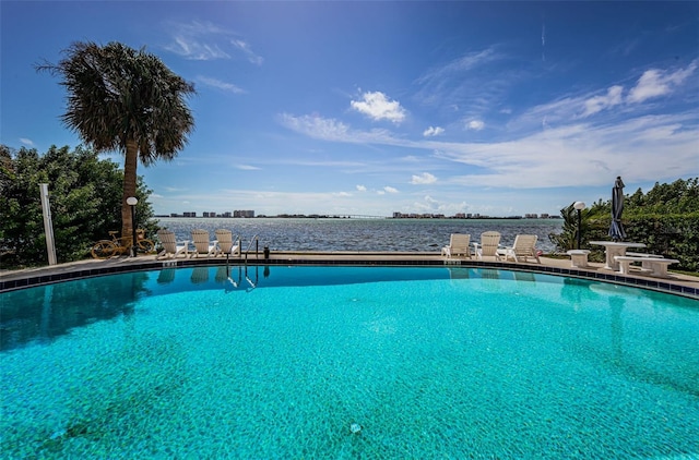 view of pool featuring a water view