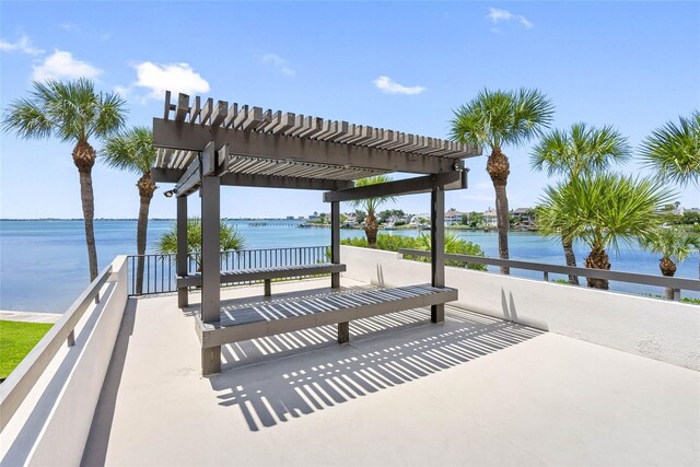 view of property's community featuring a water view and a pergola