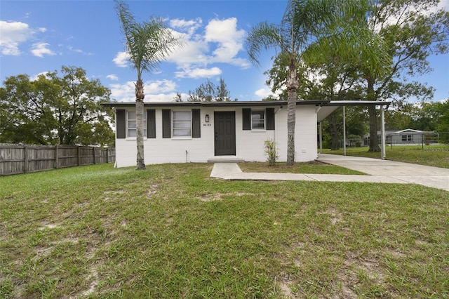 view of front of property with a front lawn and a carport