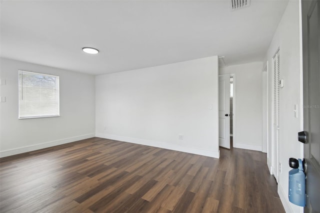 empty room with dark hardwood / wood-style floors