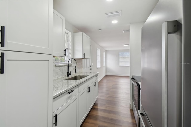 kitchen with white cabinetry, sink, plenty of natural light, and dark hardwood / wood-style floors