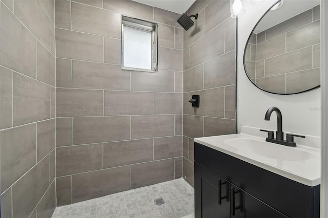 bathroom featuring vanity and tiled shower