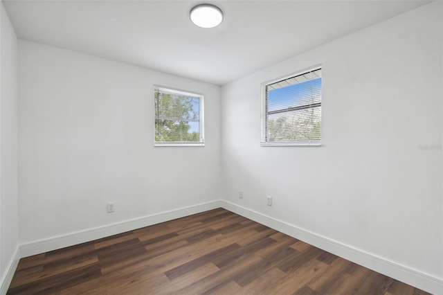 spare room with dark hardwood / wood-style floors