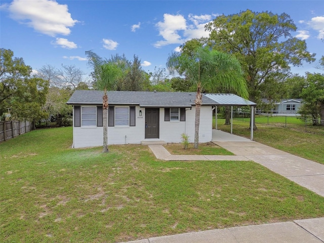 ranch-style house featuring a carport and a front lawn