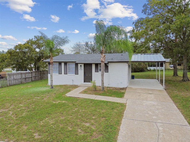 view of front of house with a front yard and a carport