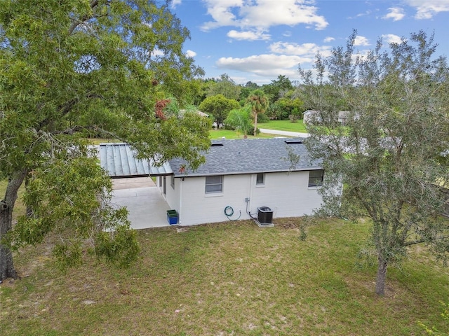 exterior space featuring a patio, central AC, and a lawn