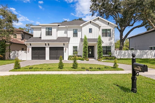 modern farmhouse style home featuring a front lawn and a garage