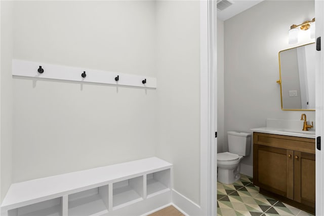 bathroom with toilet and vanity