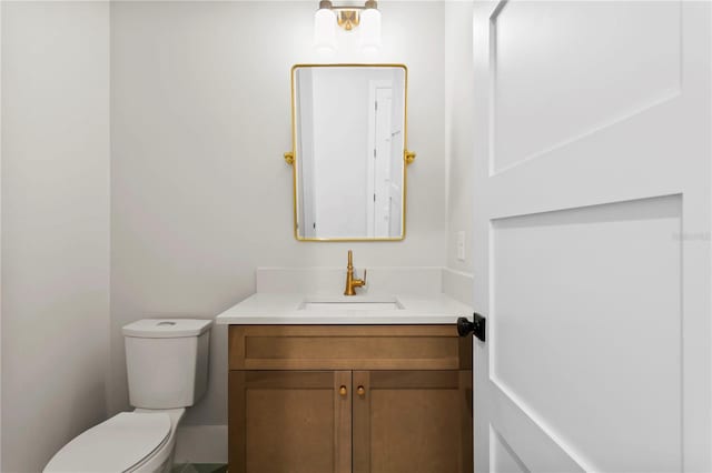 bathroom featuring toilet and vanity