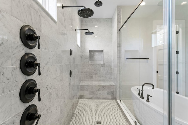 bathroom featuring shower with separate bathtub